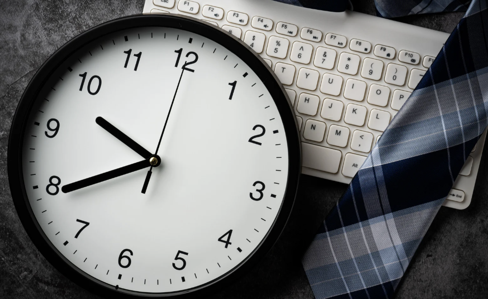 layout of clock, computer keyboard, and suit tie